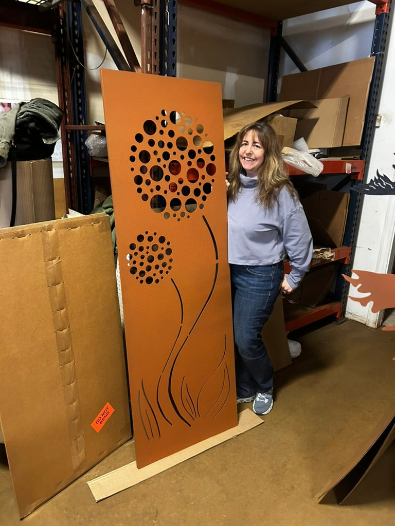 Outdoor rust privacy screen panel with circular flower holes and curved stems, heavy steel on Tampa Home & Garden Store