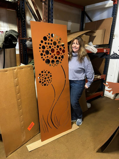 Outdoor rust privacy screen panel with circular flower holes and curved stems, heavy steel on Tampa Home & Garden Store