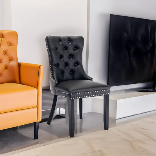 Tufted dining chairs, black and orange, with button tufting and nailhead trim; two chairs shown on Tampa Home & Garden Store