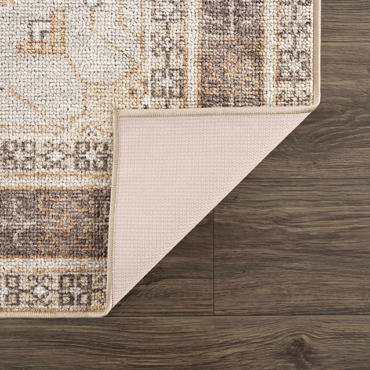 Albas Washable Area Rug by Boutique Rugs, beige taupe tufted rug with folded edge on wood floor on Tampa Home & Garden Store