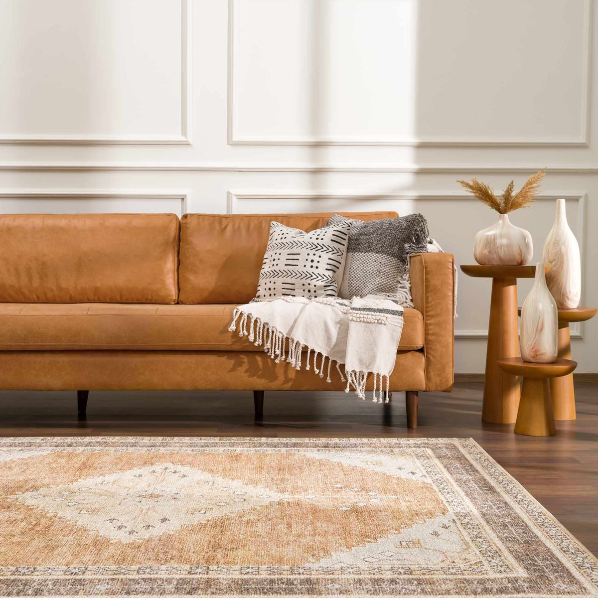 Albas washable area rug by Boutique Rugs in beige pattern under a tan sofa with pillows on Tampa Home & Garden Store