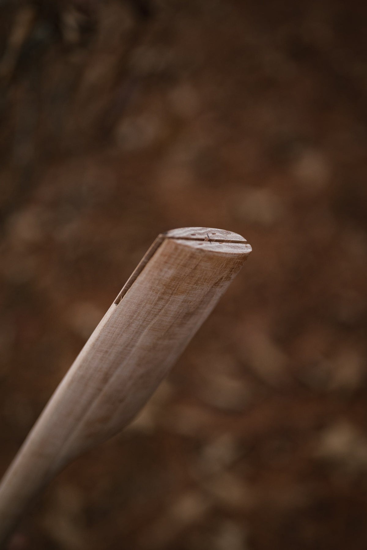 Axe handle end in natural wood with visible grain and notch on Tampa Home & Garden Store