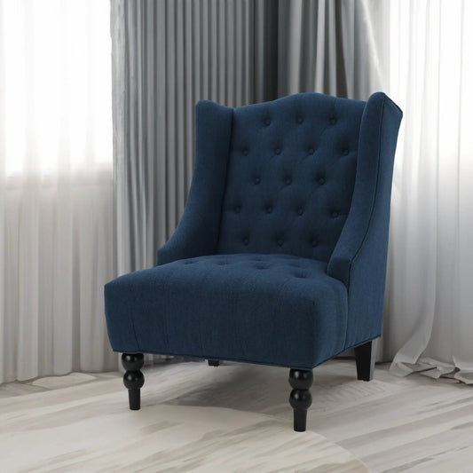 Upholstered navy blue linen wingback chair with tufted back and dark legs on Tampa Home & Garden Store