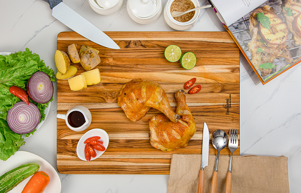 Teak cutting board natural finish, solid wood 18 inch kitchen board on counter with produce on Tampa Home & Garden Store
