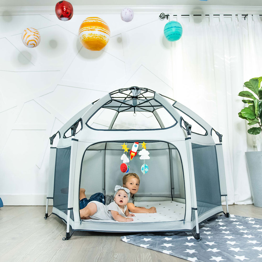 Pop 'N Go Playpen gray pop-up play yard with mesh panels; two children inside on a star rug on Tampa Home & Garden Store