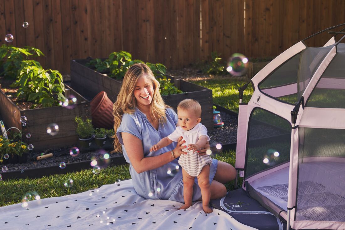 Pop 'N Go Playpen by The California Beach Company LLC, pink/gray mesh playpen outdoors on Tampa Home & Garden Store