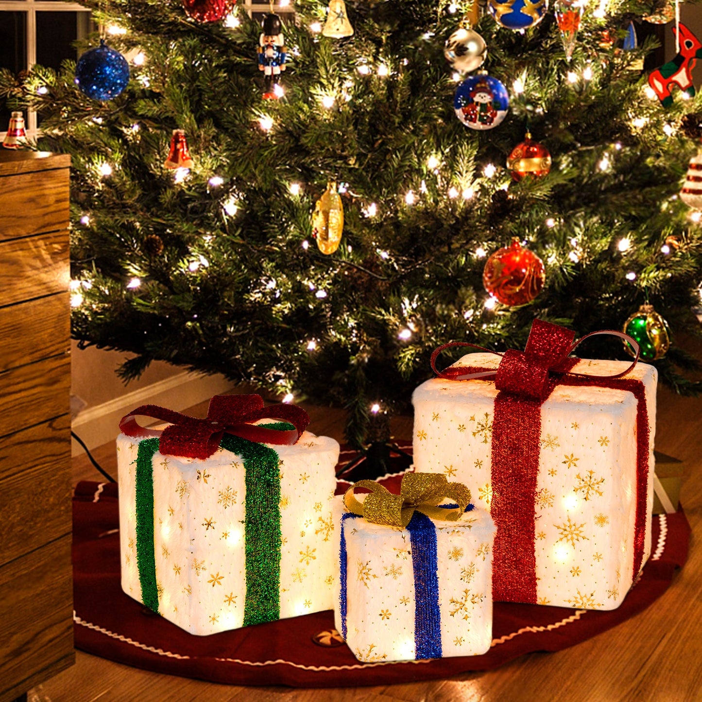 Set of 3 lighted Christmas gift boxes, white with gold snowflakes and glitter ribbons in red, green, blue on Tampa Home & Garden Store