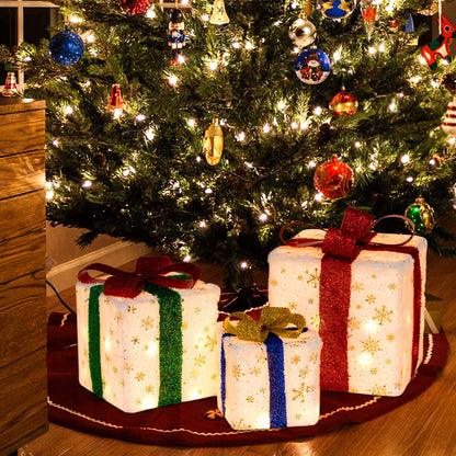 Set of 3 lighted Christmas gift boxes, white with gold snowflakes and glitter ribbons in red, green, blue on Tampa Home & Garden Store