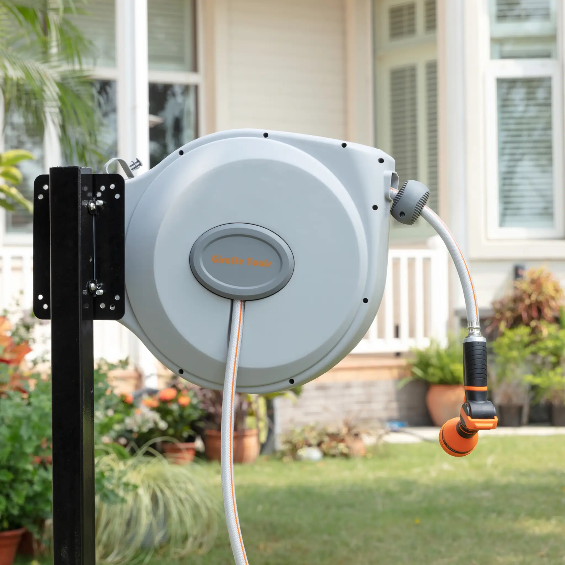 Retractable Hose Reel 65 ft 5/8 in by Giraffe Tools, gray reel on black mount with striped hose on Tampa Home & Garden Store