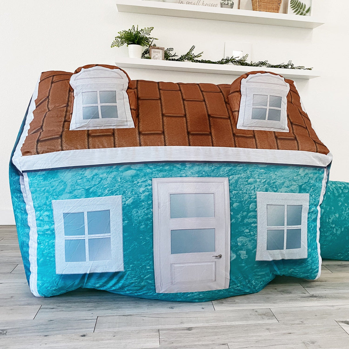AirFort Cabin inflatable play fort with blue exterior and white-framed windows on Tampa Home & Garden Store