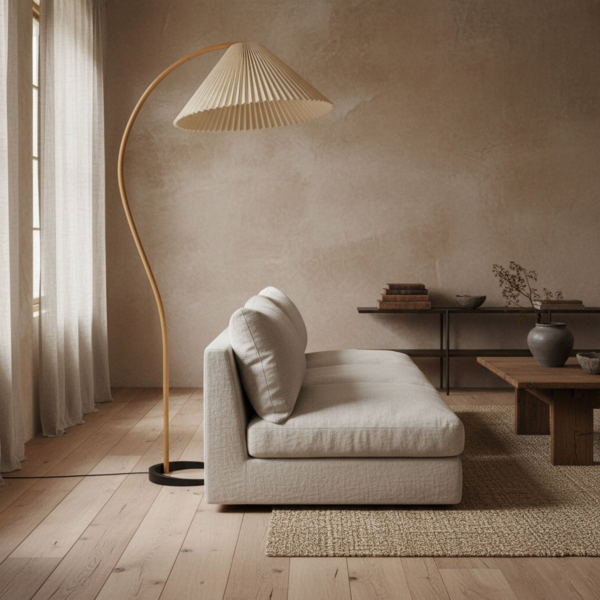 Arbora Arc floor lamp in beech wood with pleated shade beside beige sofa in living room on Tampa Home & Garden Store