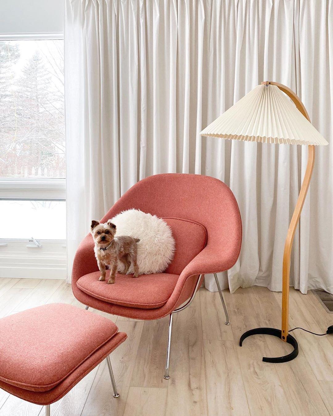 Arbora Arc floor lamp in beech wood with pleated shade beside coral pink chair and ottoman on Tampa Home & Garden Store