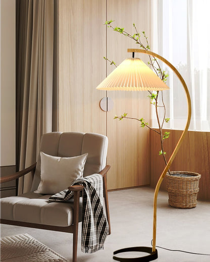 Arbora Arc Floor Lamp with beech wood arc and pleated shade by Moktan Sabai in living room on Tampa Home & Garden Store