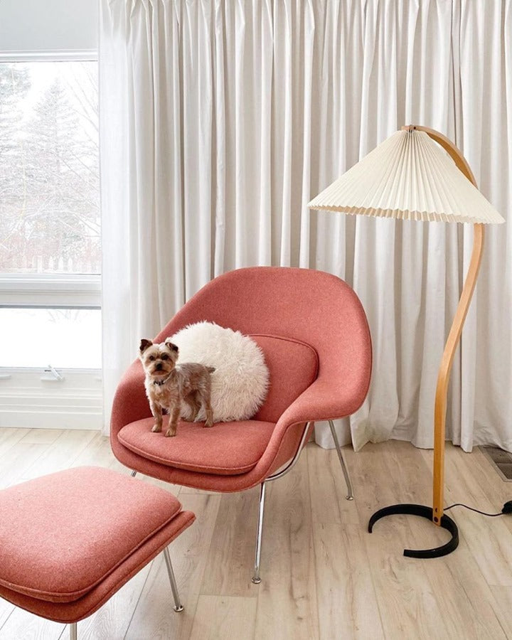 Arbora Arc Floor Lamp by Moktan Sabai in beech wood with pleated shade beside pink lounge chair on Tampa Home & Garden Store