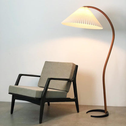 Arc floor lamp in beech wood with a pleated cream shade beside a gray upholstered lounge chair on Tampa Home & Garden Store