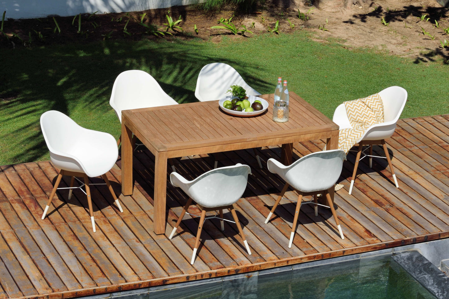 Chamonix resin and FSC wood arm chairs, six white chairs surround a wooden dining table on Tampa Home & Garden Store
