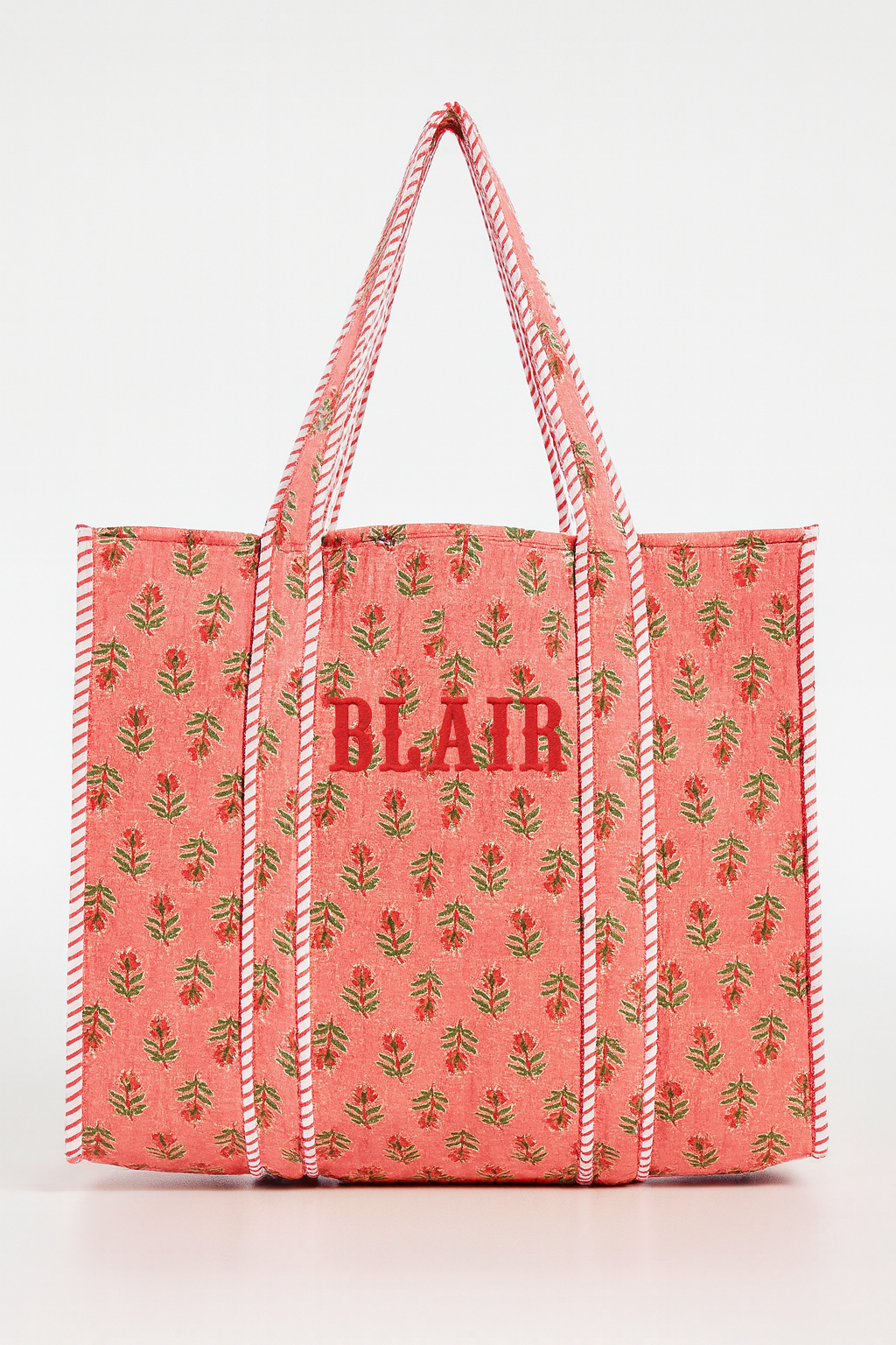 Pink Field Tote with green leaf print, red BLAIR lettering, striped handles on Tampa Home & Garden Store