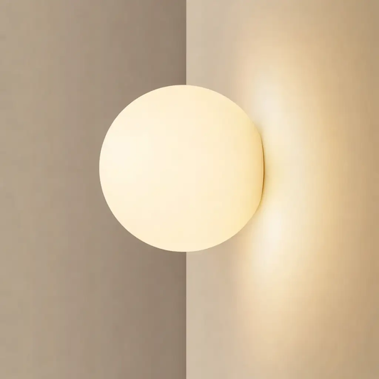 Glass Ball Wall Sconce LED with frosted glass and warm white glow on beige wall on Tampa Home & Garden Store