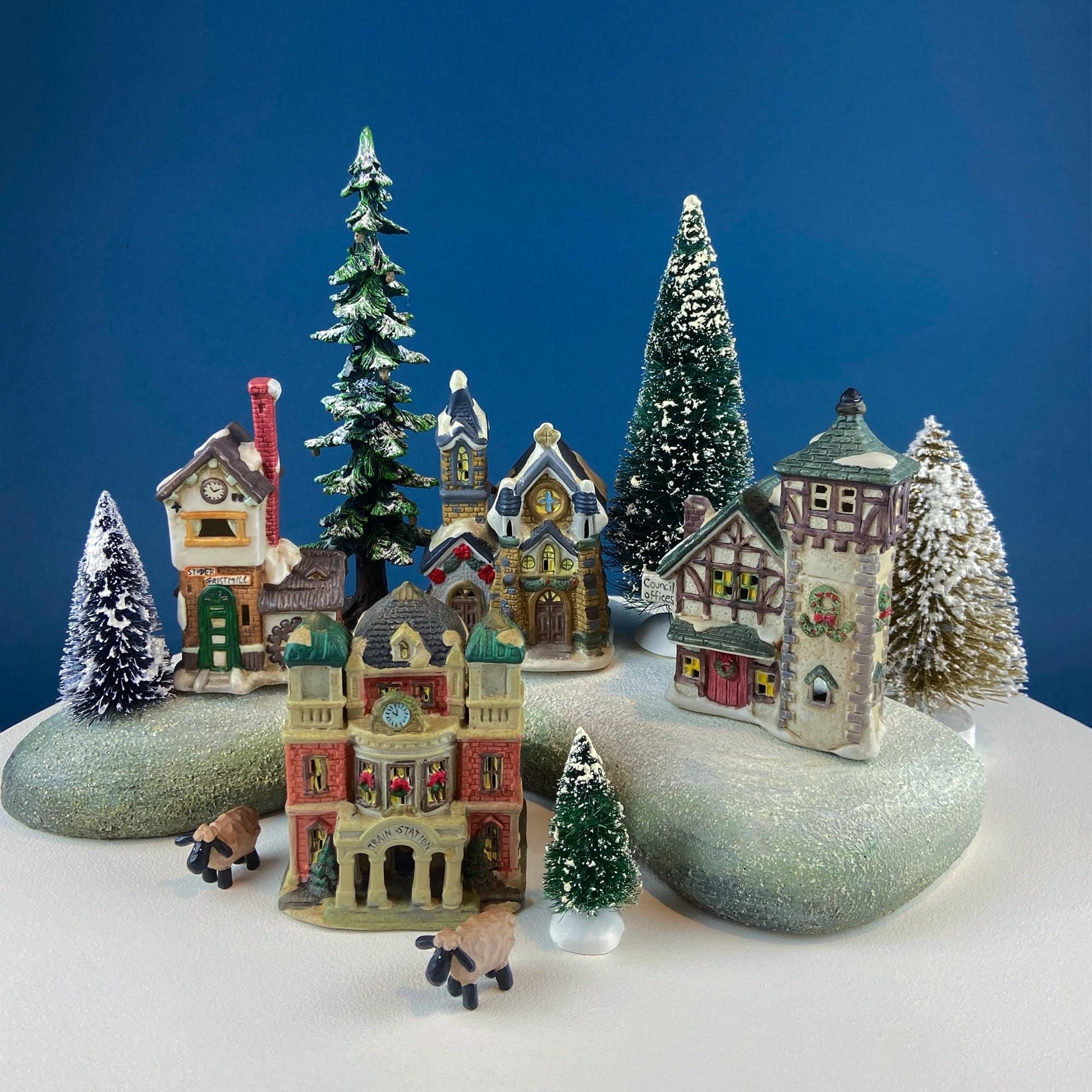 Christmas Village Collection of Small Illuminated Houses. Set of 4 Bldgs: Mill, 2 Churches, Train St., Council Offices, 2 Sheep and 3 Pines. - Tampa Home & Garden Store