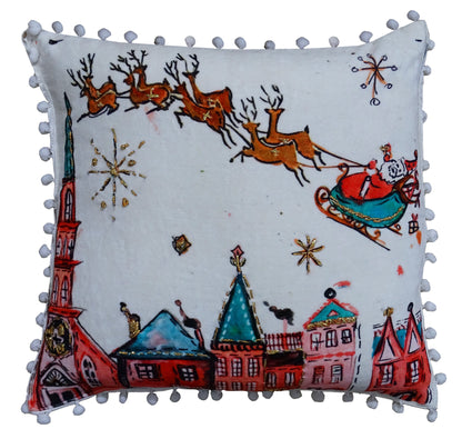 Vibhsa Santa pillow 18x18 with sleigh and reindeer print, white fabric, pom-pom trim on Tampa Home & Garden Store
