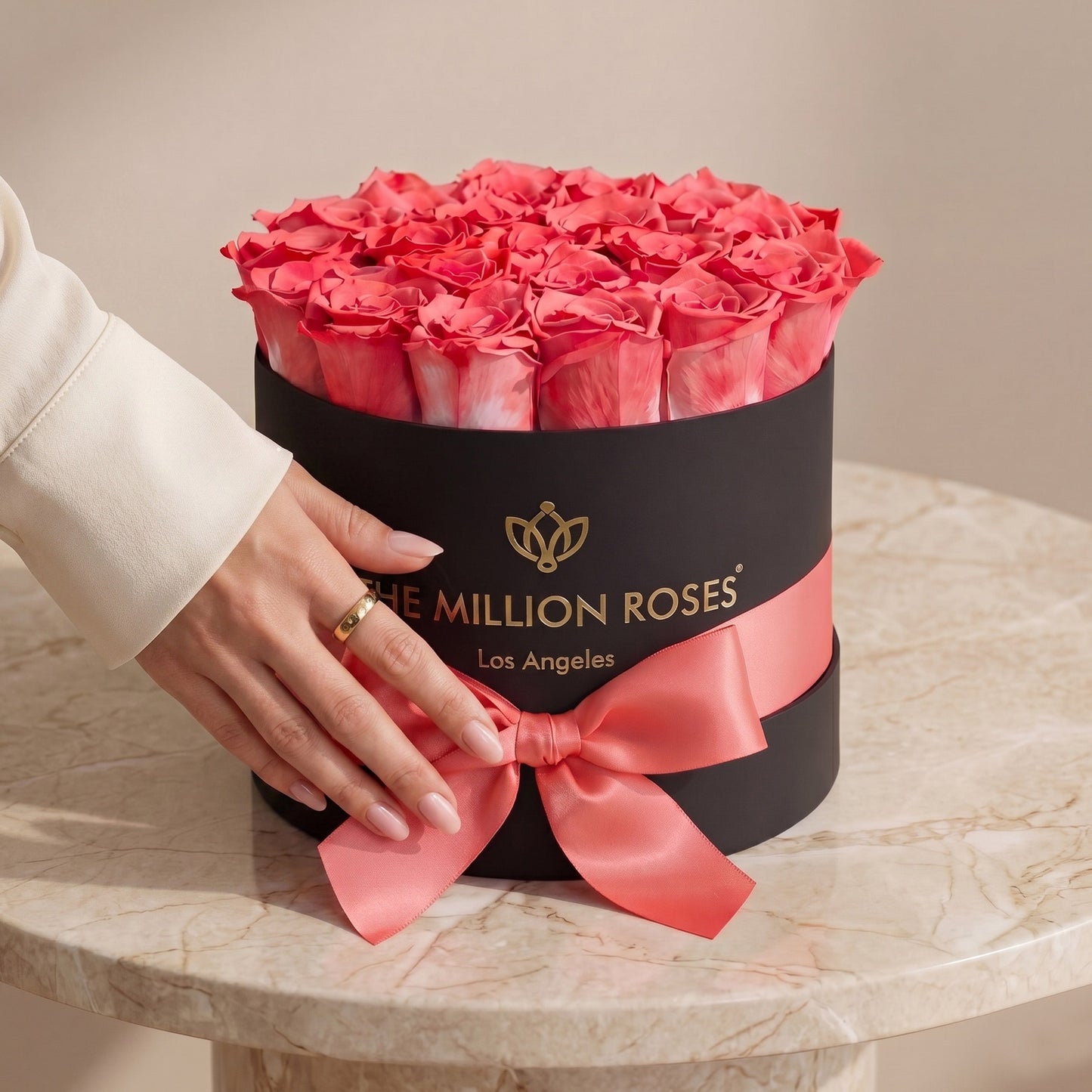 Coral pink roses in a black round box with pink satin ribbon The Million Roses on Tampa Home & Garden Store