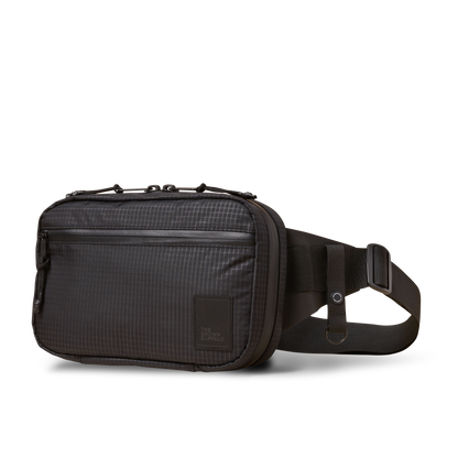 Concealsling crossbody bag by The Brown Buffalo in dark gray grid fabric with logo patch on Tampa Home & Garden Store