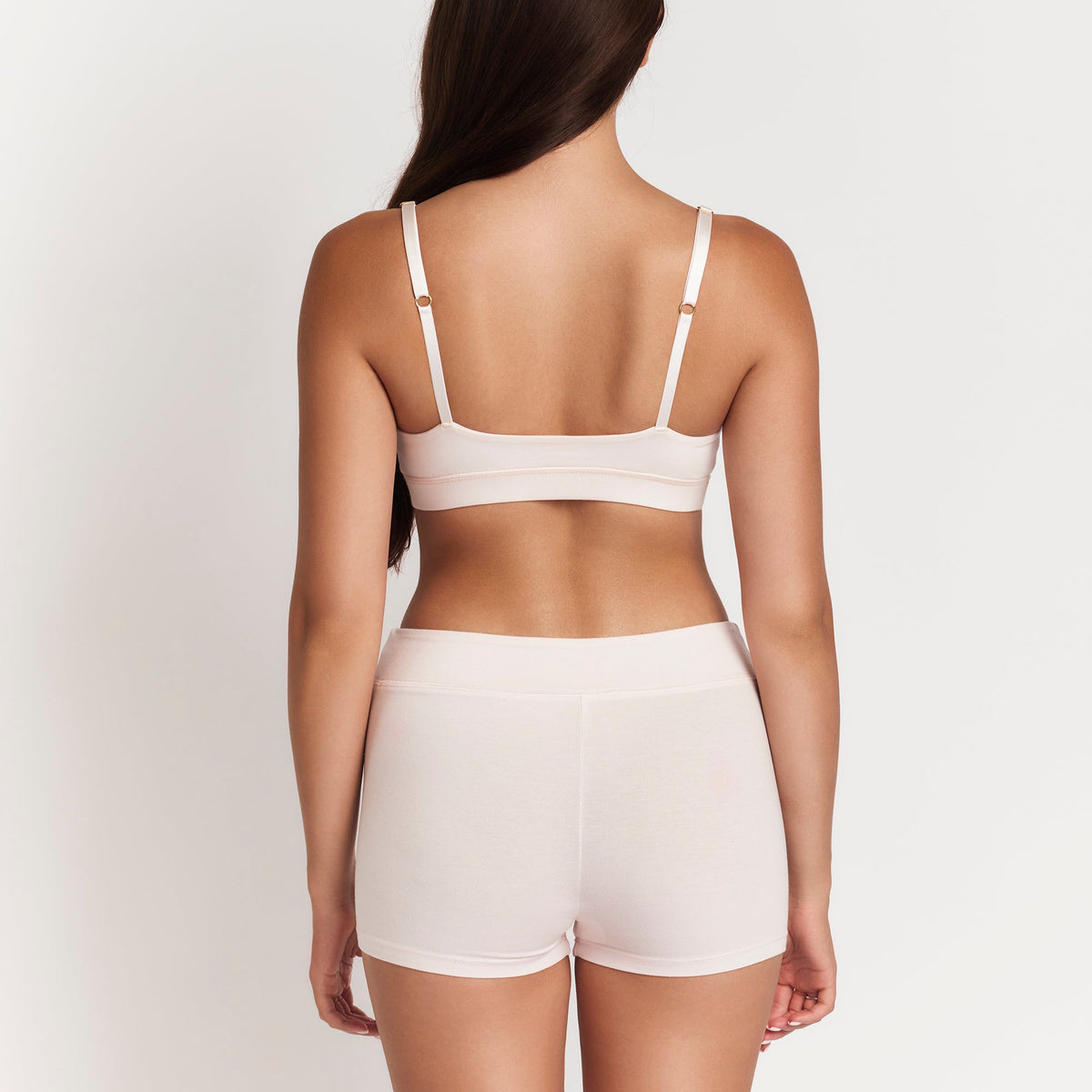 Net Positive organic cotton boyshorts in pale pink, back view of model on Tampa Home & Garden Store