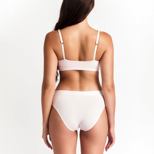 Mid-Rise Brief in pale pink organic cotton by Net Positive, back view on model on Tampa Home & Garden Store