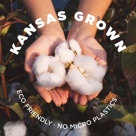 Raw cotton stuffing/batting, all natural from Thunder Acres, held in hands on Tampa Home & Garden Store