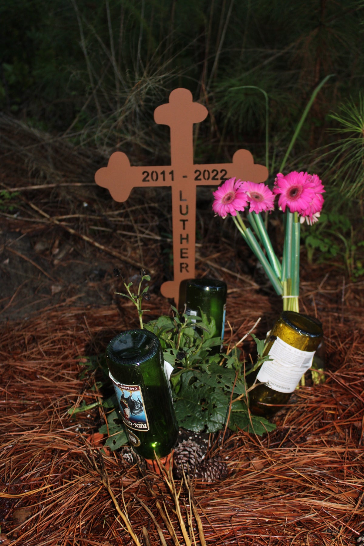 Rust-colored memorial cross wall art, 25 inches, garden decor with pink Gerbera daisies on Tampa Home & Garden Store