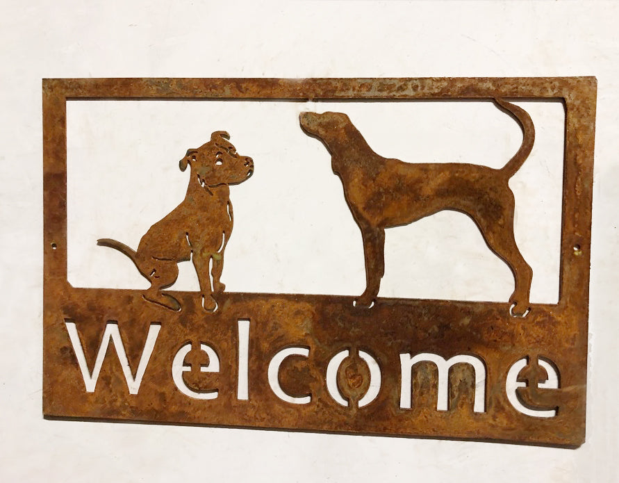 Custom metal pet sign with rusted frame featuring two dog silhouettes and a Welcome cutout on Tampa Home & Garden Store