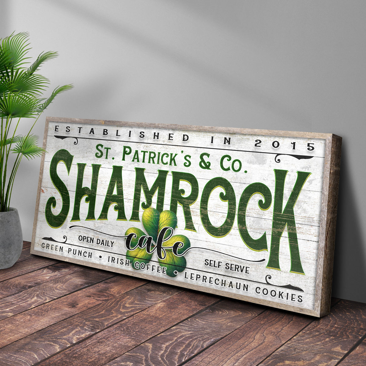 Canvas sign Shamrock Cafe with white background and green SHAMROCK lettering on wood frame on Tampa Home & Garden Store