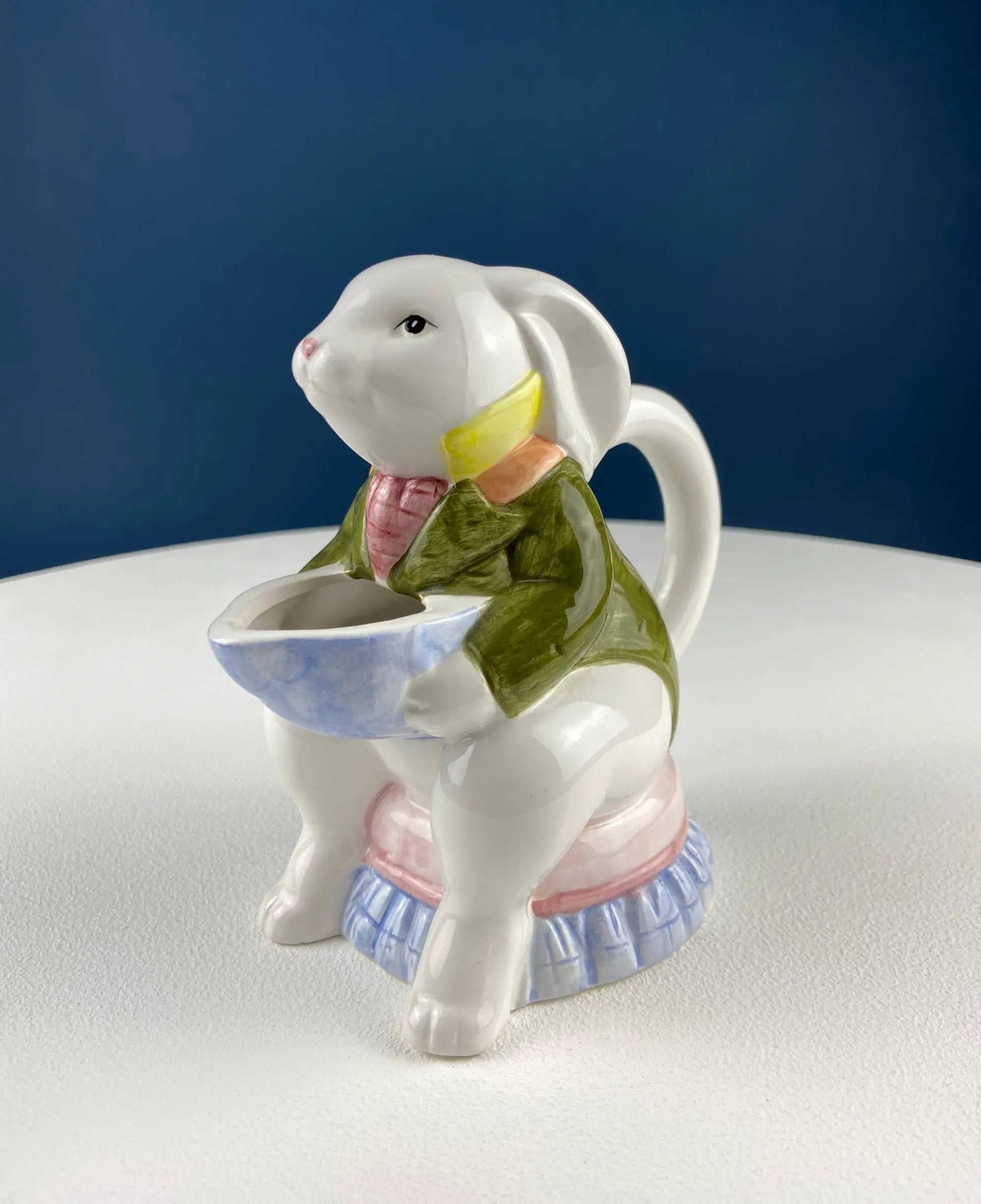 Ceramic bunny creamer dispenser in pastel clothing holding a blue bowl on Tampa Home & Garden Store