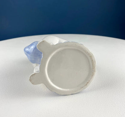 White ceramic plate with scalloped rim and blue edge on white surface on Tampa Home & Garden Store