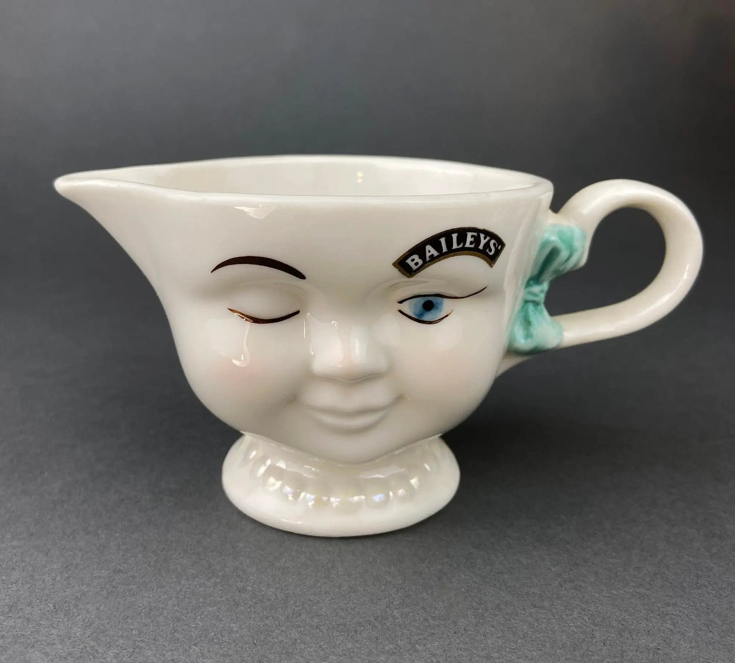 Cute bunny armchair creamer dispenser, white ceramic with teal bow and blue eye accents on Tampa Home & Garden Store
