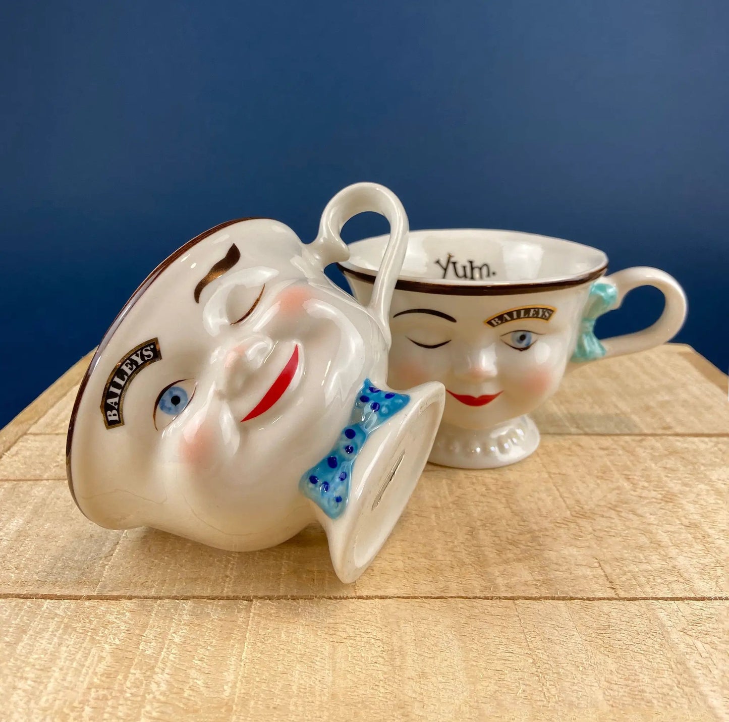 Bunny armchair creamer pair; white ceramic bunny faces with brown trim and blue bow on Tampa Home & Garden Store