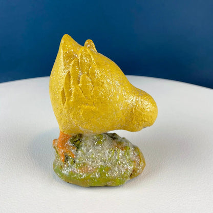 Cute yellow baby chick figurine with glitter texture on a base for Easter decor on Tampa Home & Garden Store
