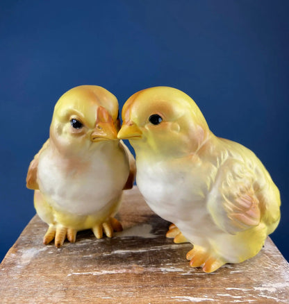 Pair of cute plump yellow baby chick figurines for Easter decor on a rustic wood surface on Tampa Home & Garden Store