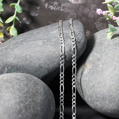 3.0mm 14k white gold solid Figaro chain necklace with twin links draped on smooth rocks on Tampa Home & Garden Store