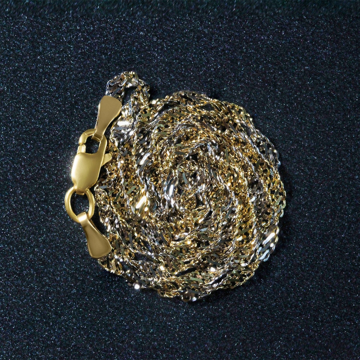 2.0mm two-tone 14k Singapore chain necklace in gold and silver, coiled on Tampa Home & Garden Store