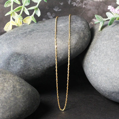 14k yellow gold Singapore chain necklace 1.0mm with delicate textured links on rocks on Tampa Home & Garden Store