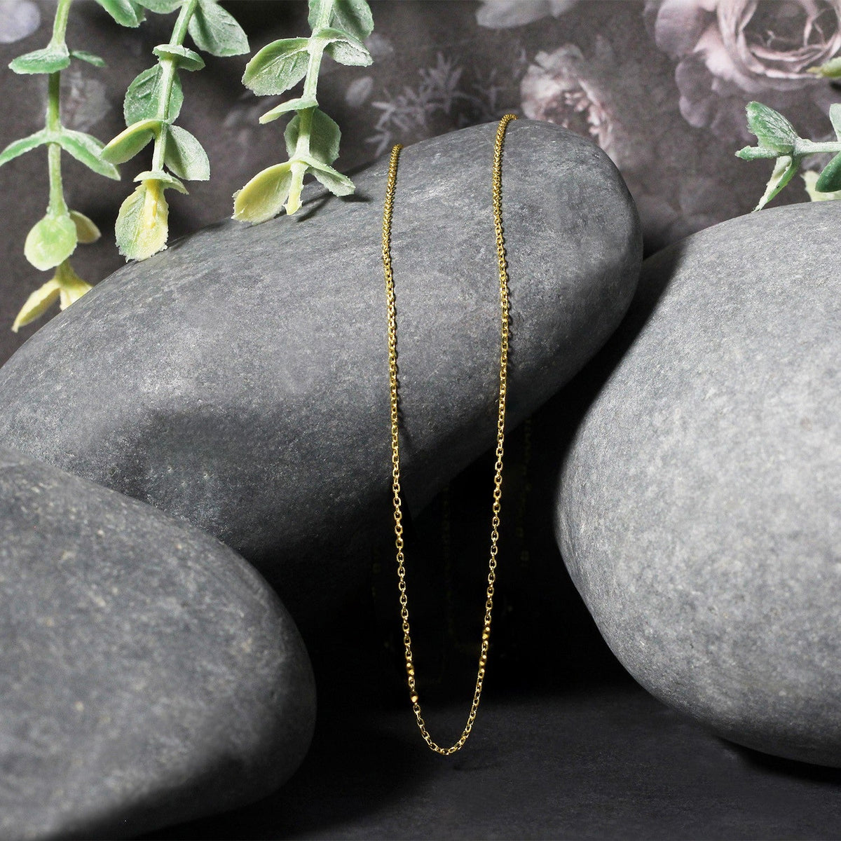14k yellow gold diamond-cut cable chain necklace 0.8mm, slender gold link on gray stones on Tampa Home & Garden Store
