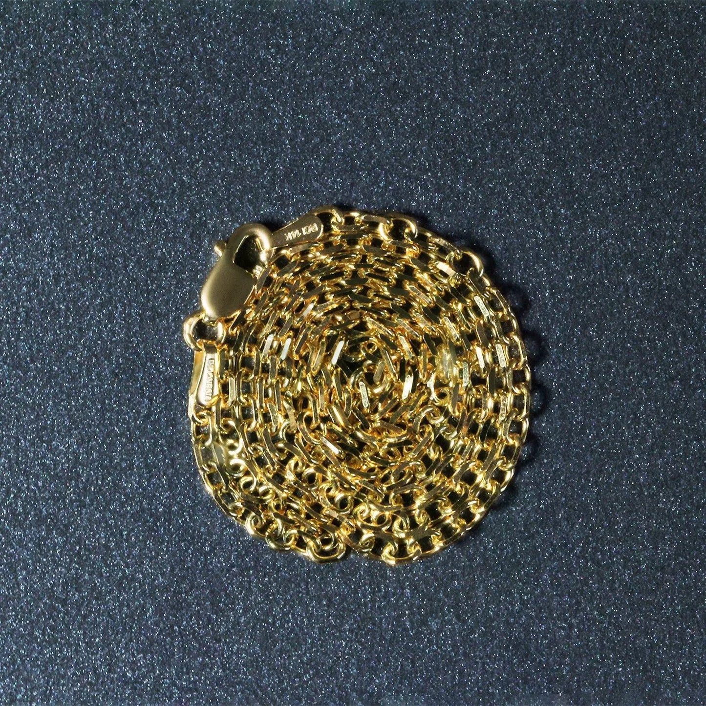 2.3mm 14k yellow gold diamond-cut cable link chain necklace by Bids.com, coiled into a circular mass on Tampa Home & Garden Store