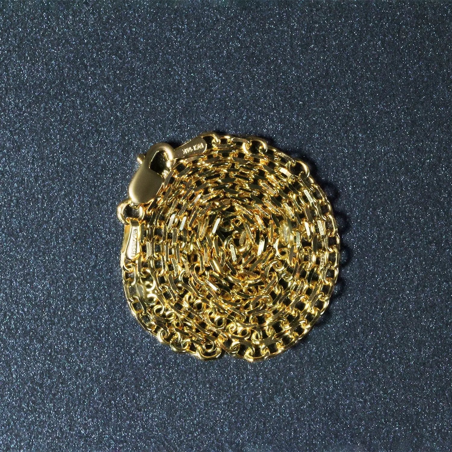 2.3mm 14k yellow gold diamond-cut cable link chain necklace by Bids.com, coiled into a circular mass on Tampa Home & Garden Store