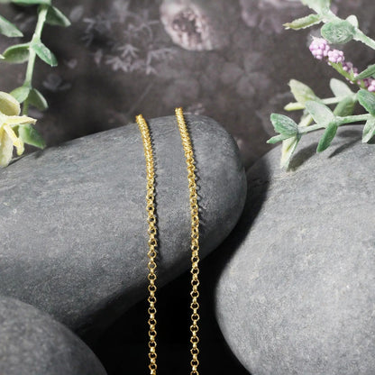 14k yellow gold rolo chain necklace 1.9mm, two delicate chains displayed on smooth gray stones on Tampa Home & Garden Store