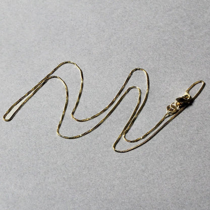 Two 14k yellow gold box chain necklaces, 0.45mm, with lobster clasps on gray background on Tampa Home & Garden Store