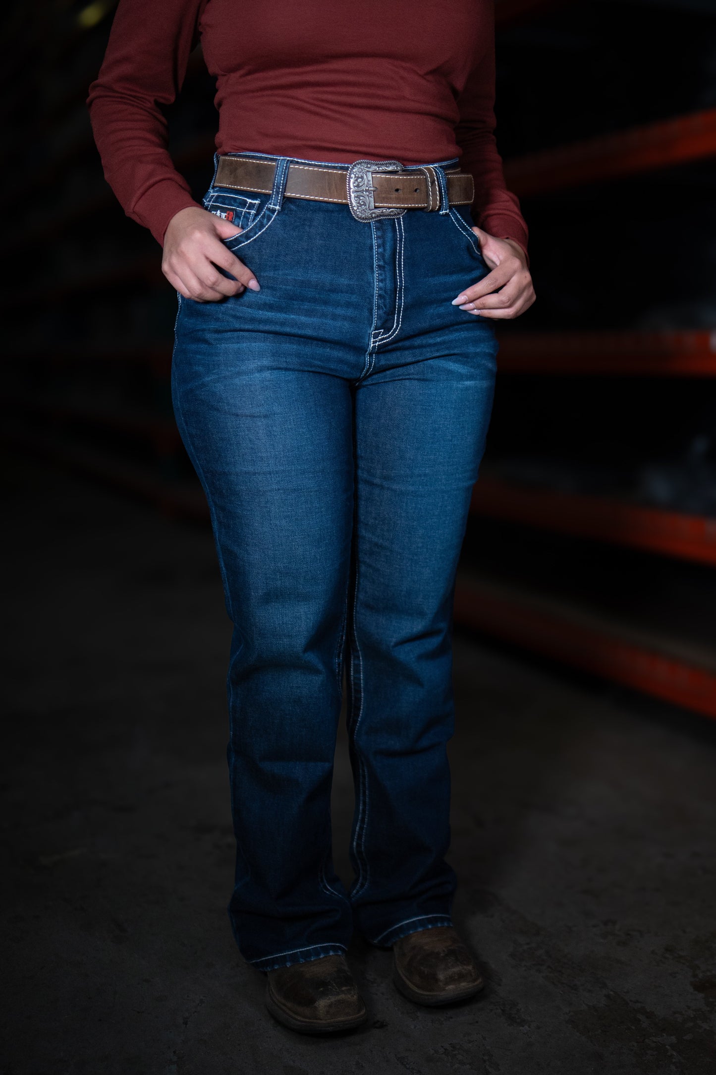 Women's Static FR high-waisted jeans in blue denim with brown belt on Tampa Home & Garden Store