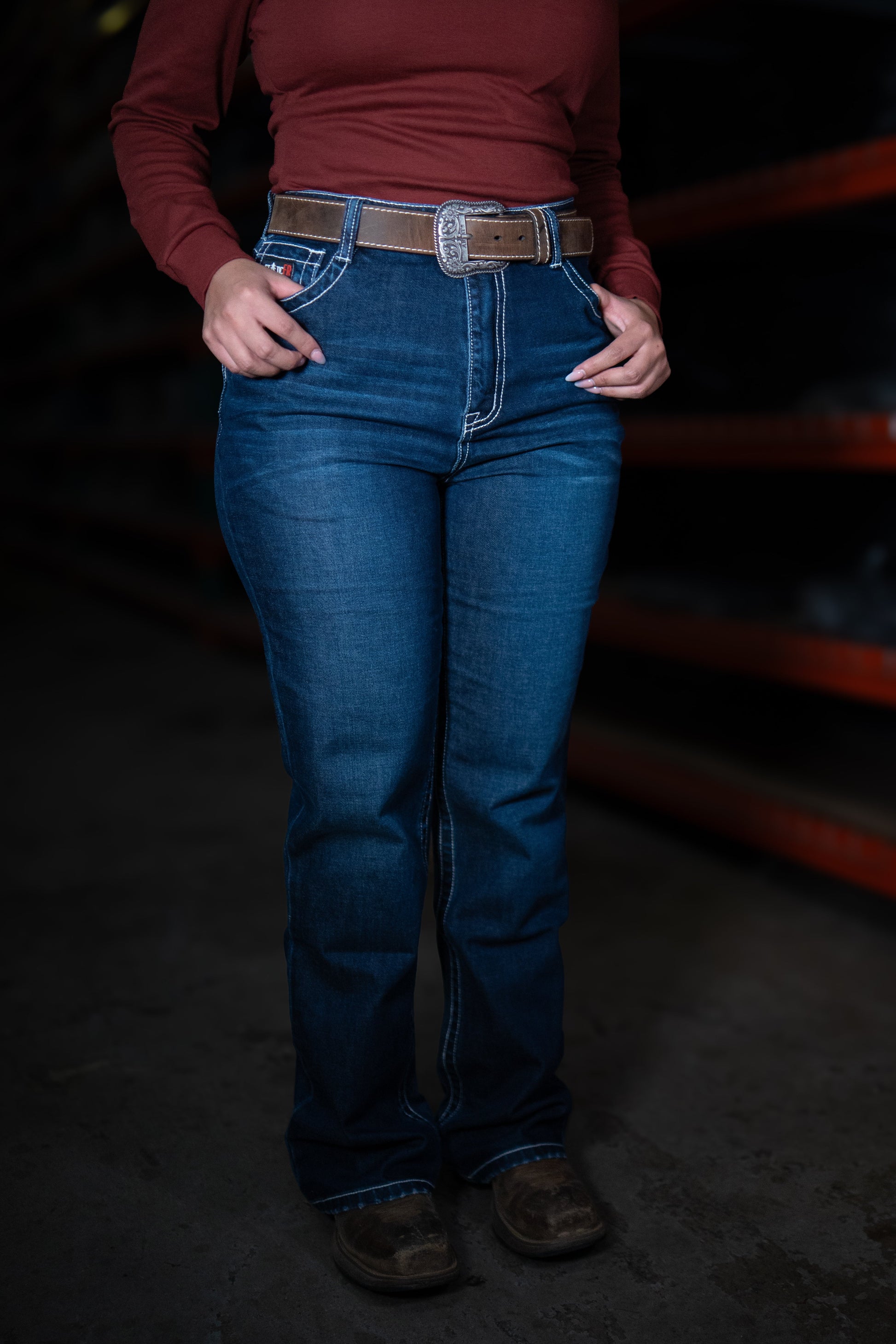 Women's Static FR high-waisted jeans in blue denim with brown belt on Tampa Home & Garden Store