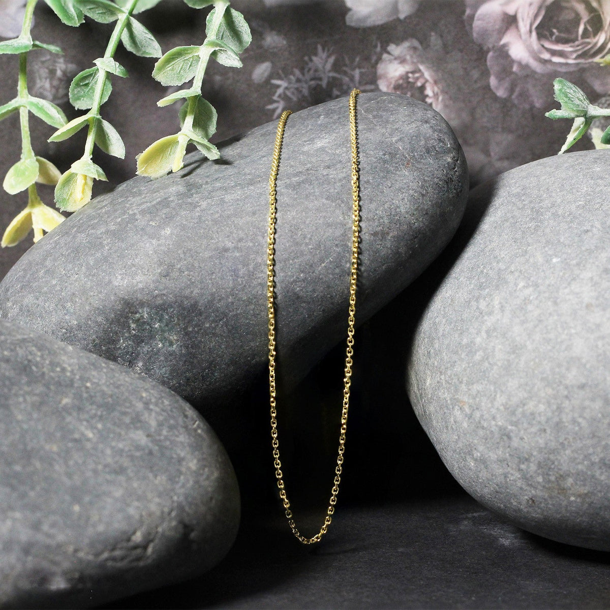 18k yellow gold diamond-cut cable link necklace, two 1.10 mm chains displayed on gray stones on Tampa Home & Garden Store