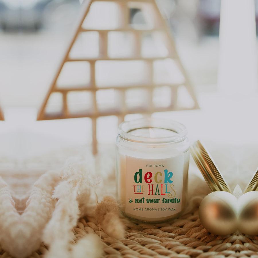 Deck The Halls Candle by Gia Roma in a clear glass jar with white wax and a colorful label on Tampa Home & Garden Store